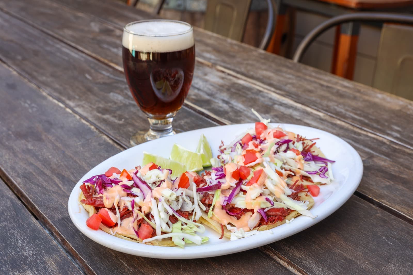 Corned beef tacos with cabbage, tomatoes, and house sauce